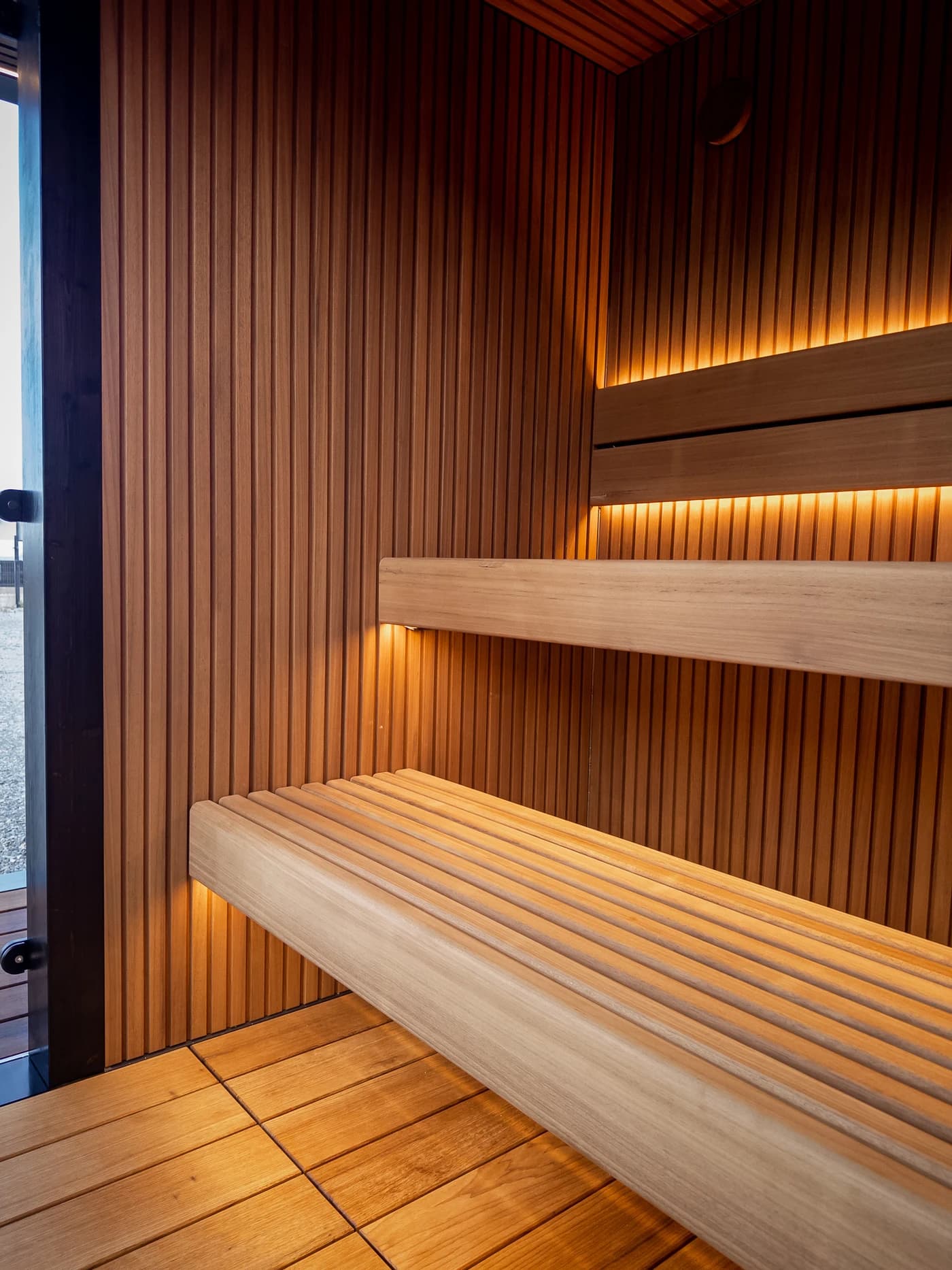 Timber sauna benches photographed inside a built MODUM sauna